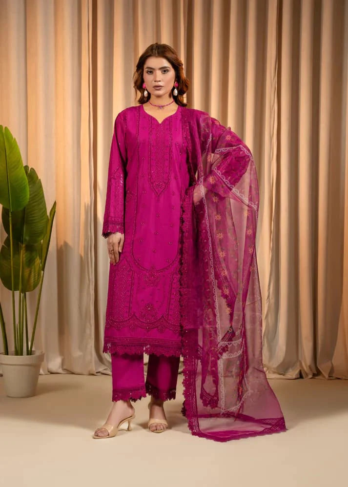 Woman wearing a pink traditional outfit with a dupatta against a beige curtain background