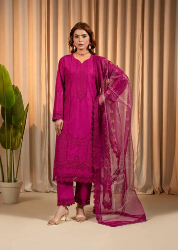 Woman wearing a pink traditional outfit with a dupatta against a beige curtain background