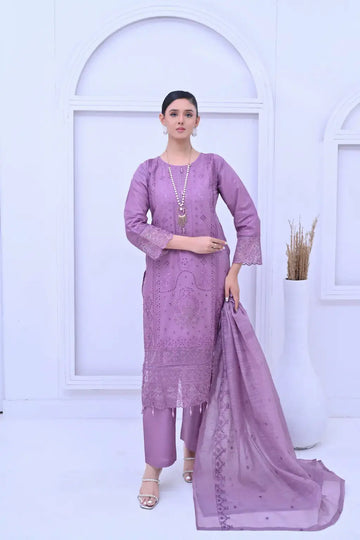 Woman modeling a lavender 3-piece embroidered suit with cutwork details and a sheer dupatta.