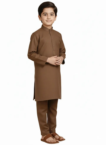 Young boy wearing a brown traditional outfit on a white background