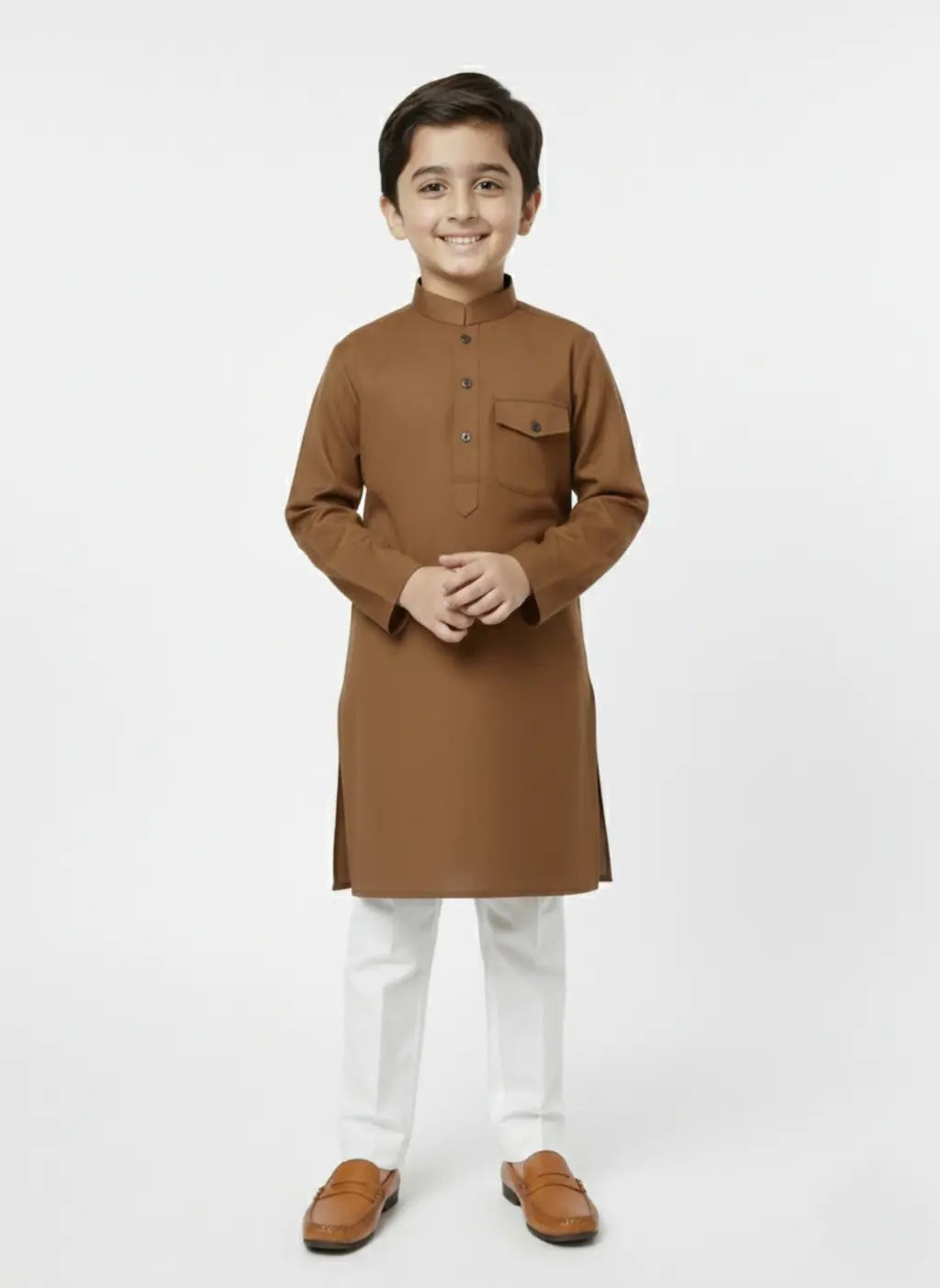 Young boy wearing a brown kurta with white pants on a white background