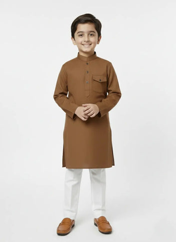 Young boy wearing a brown kurta with white pants on a white background
