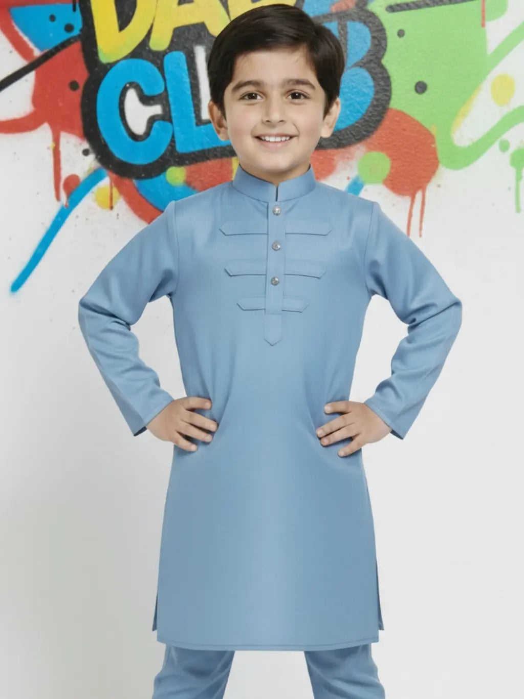 Child wearing a light blue kurta with colorful graffiti background