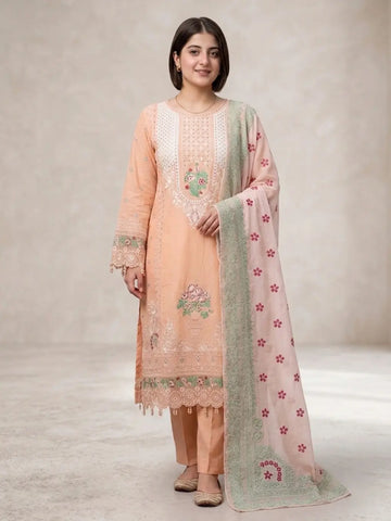 Woman wearing a peach-colored embroidered outfit with a matching dupatta on a neutral background