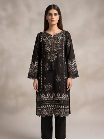 Woman wearing a black embroidered kurta with a plain background