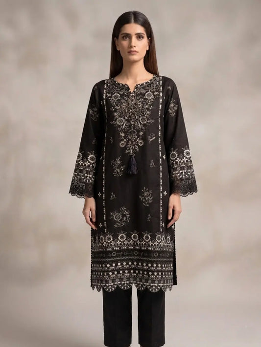 Woman wearing a black embroidered kurta with a plain background