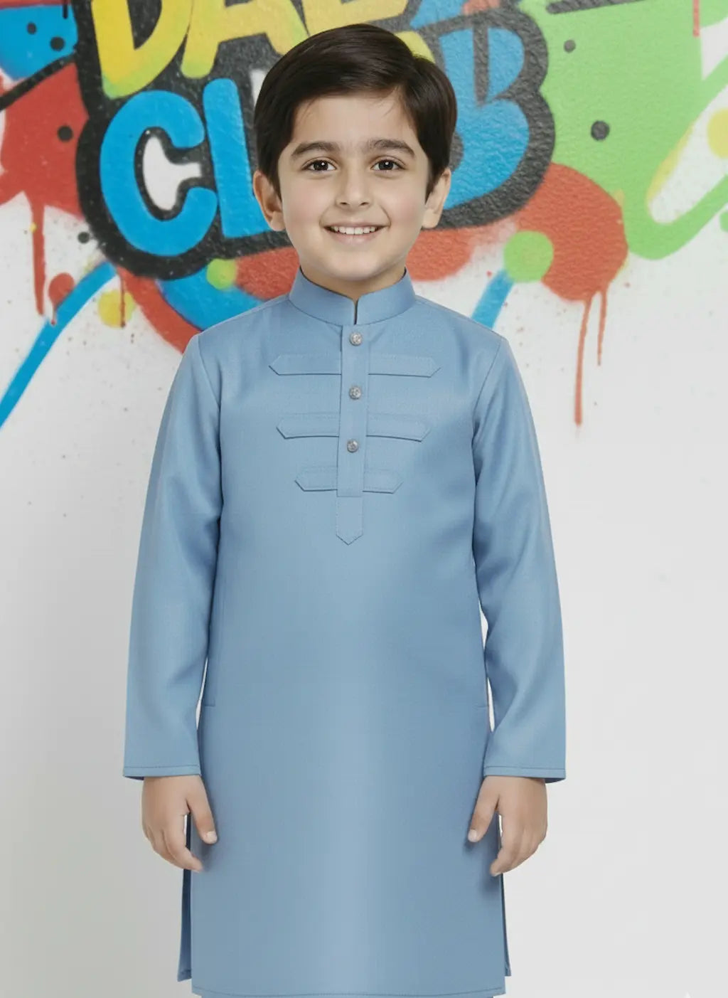 Child wearing a light blue kurta against a colorful graffiti background