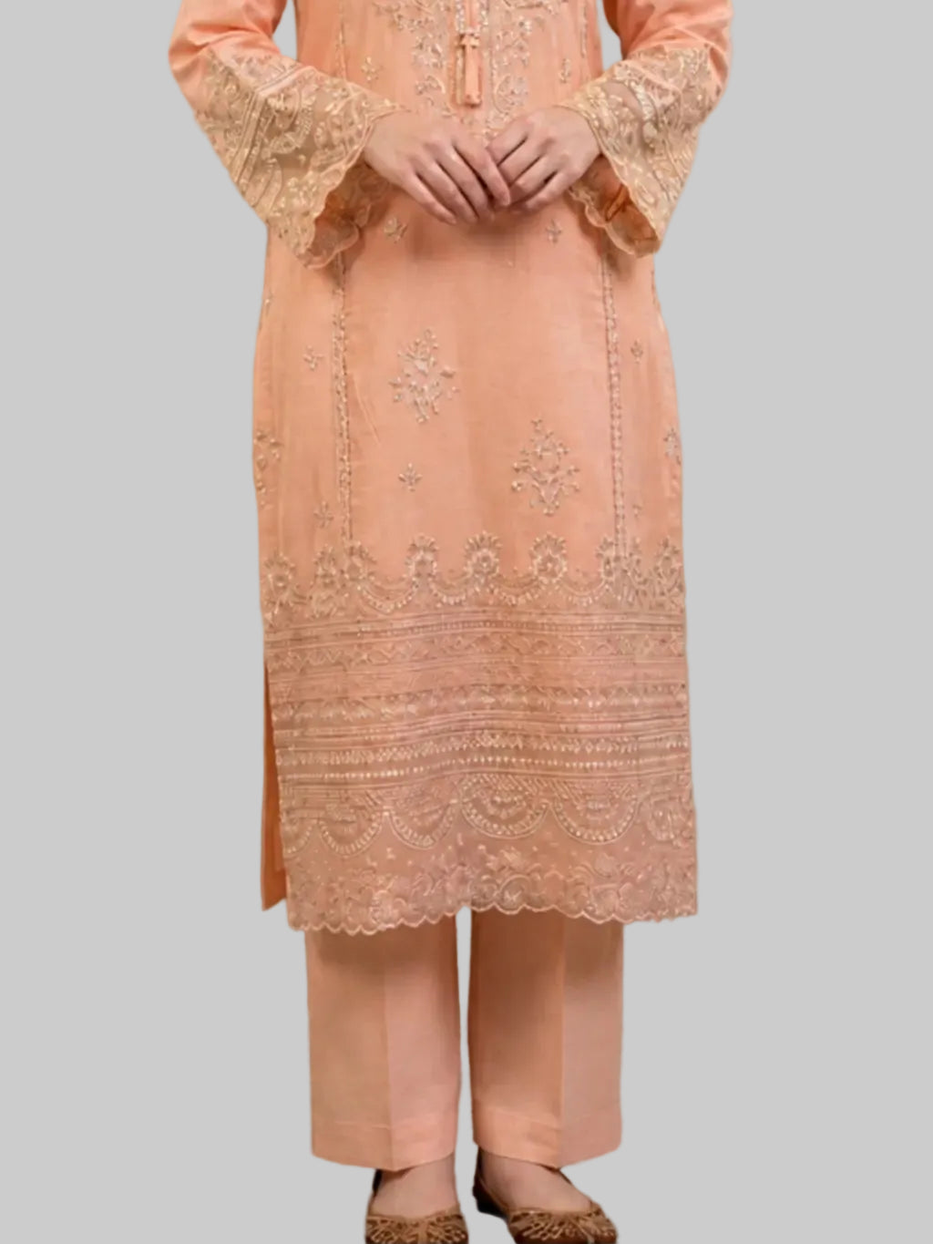 Peach embroidered outfit with matching pants on a neutral background