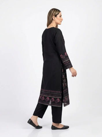 Woman wearing a black embroidered kurta with black pants on a white background