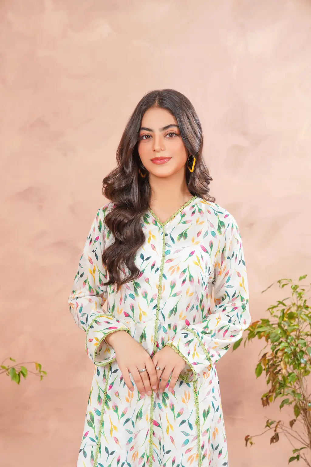 Woman wearing a floral dress against a pink background