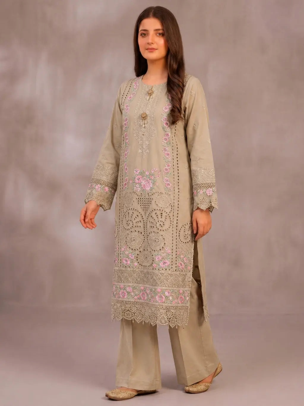 Model wearing a 3PC beige floral Chikankari embroidered cotton lawn suit with pink floral details and intricate laser-cut lace border.