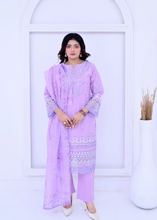 Woman wearing a light purple traditional outfit with white embroidery against a white background