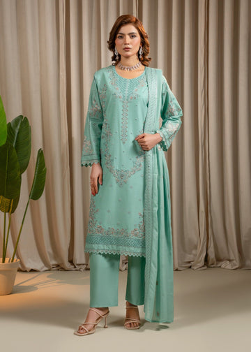 Woman wearing a light blue embroidered outfit with a plain background