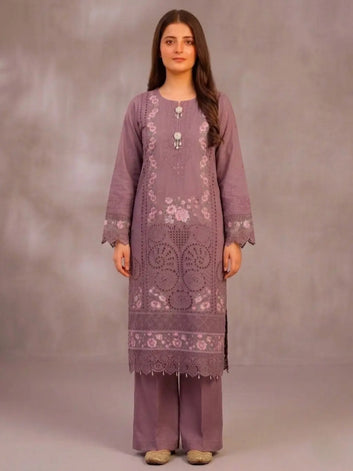 Woman wearing a purple embroidered traditional outfit against a plain background