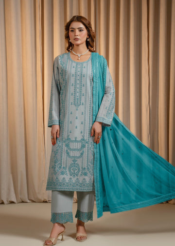 Woman wearing a light blue embroidered outfit with a matching dupatta against a beige curtain background