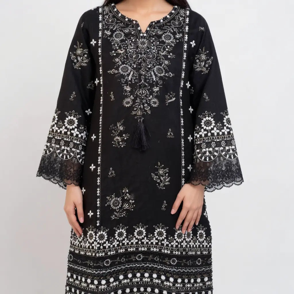 Black dress with white intricate patterns on a plain background