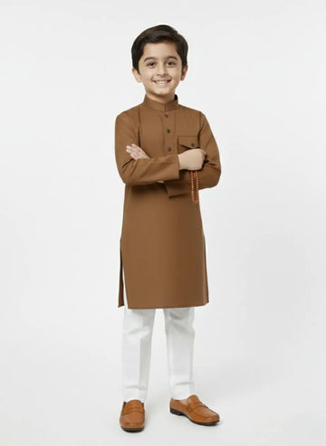 Young boy wearing a brown kurta with white pants on a white background