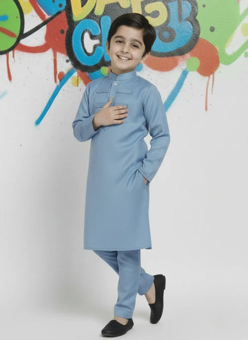 Child wearing a iceblue kurta with a colorful graffiti wall in the background