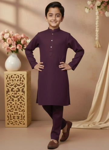 Child wearing a purple kurta with a decorative background